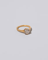 View from the side of past version of the Super White Diamond Barragán Ring on light color background.