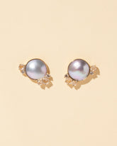 Mabe Pearl Cluster Earrings on light color background.