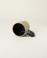 Detail view of Recreation Center Dalmatian Stripe Mugs on light color background.