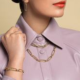 product_details::Link Huggie Hoop Earrings, Pavé Link Necklace, Link Necklace and Link Bracelet on model.