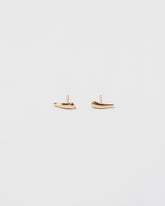 Gold Solid Left Facing and Gold Solid Right Facing One & Others Stud Earring Singles on light color background.