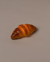 In-use detail view of the Pampshade Croissant Lamp on light color background.