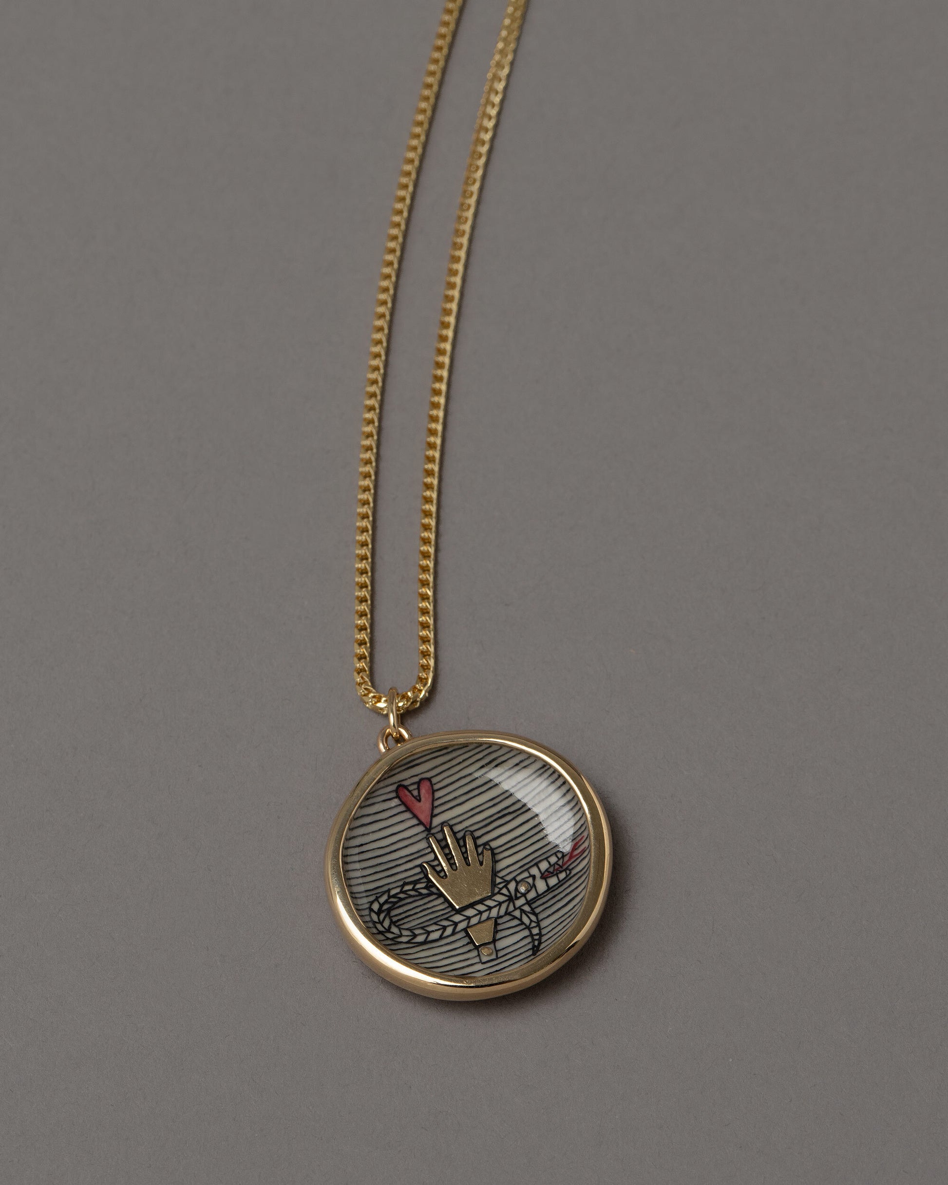 Closeup details of An Homage to Suzanne Pendant Necklace on grey color background.
