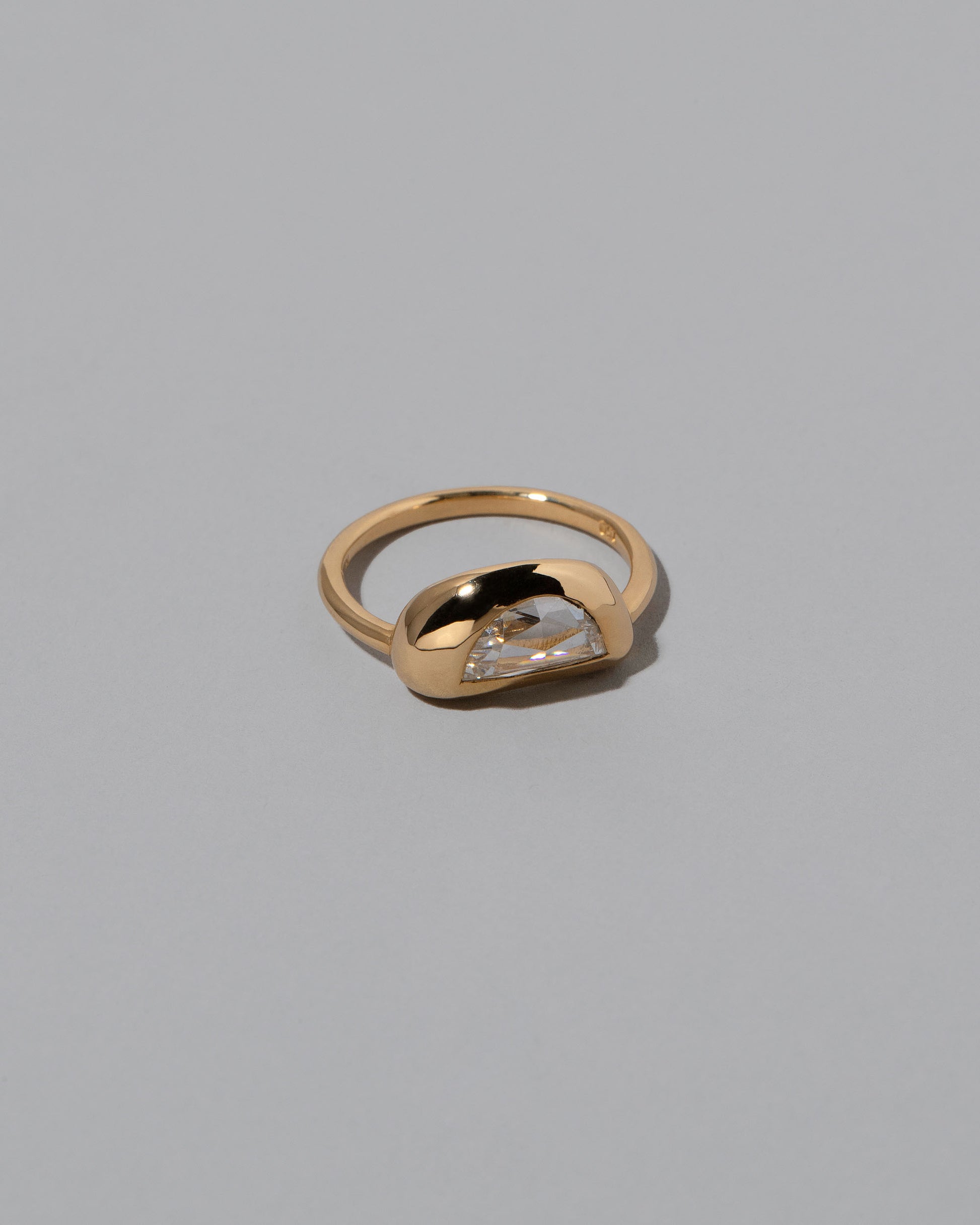 View from the side of the Lined Up Ring on light color background.