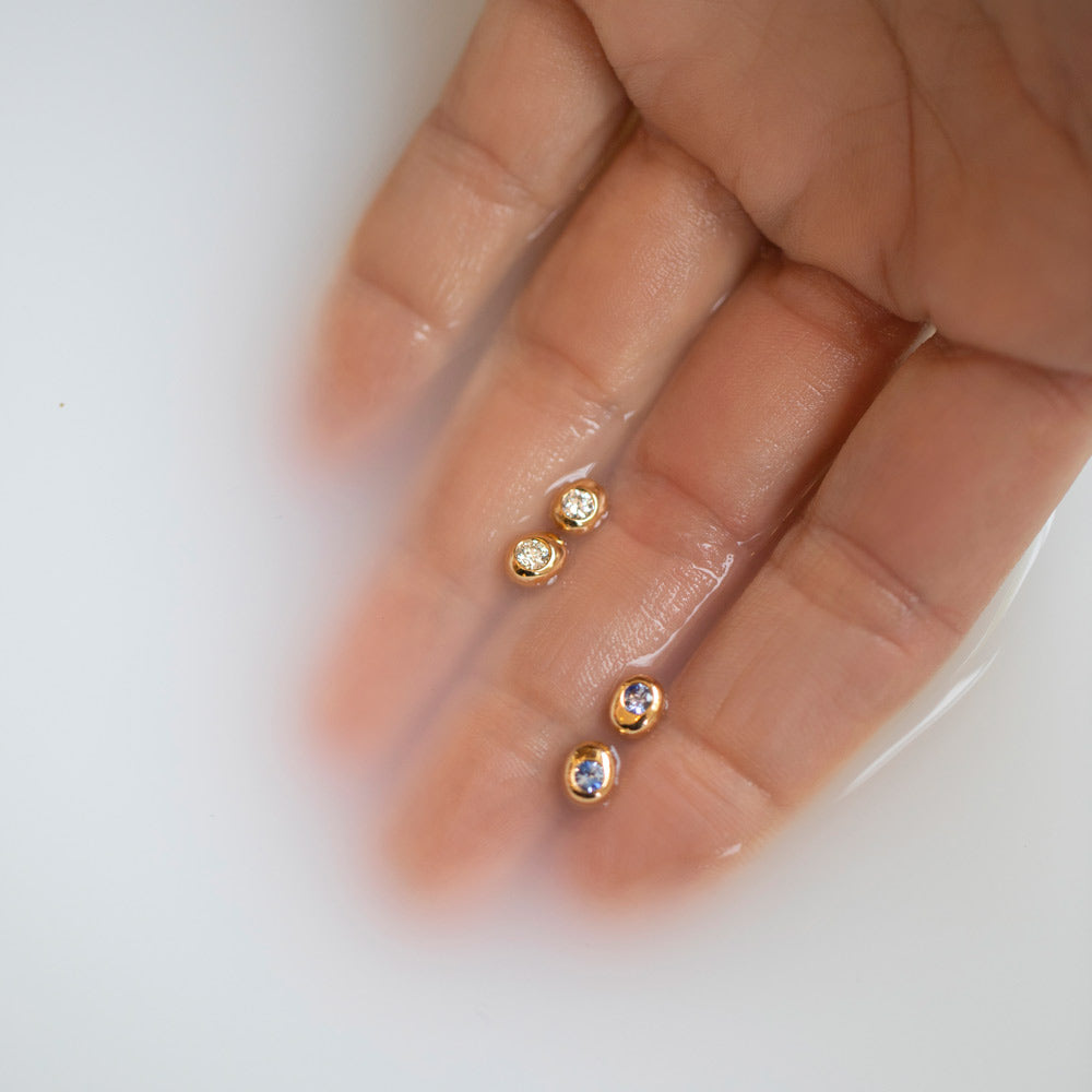 product_details::Styled image featuring the Diamond and Sapphire Birthstone Level Stud Earrings.