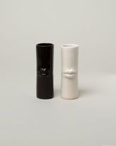 Group of Bonam Kim White and Black Lip Pillar Vases on light color background.