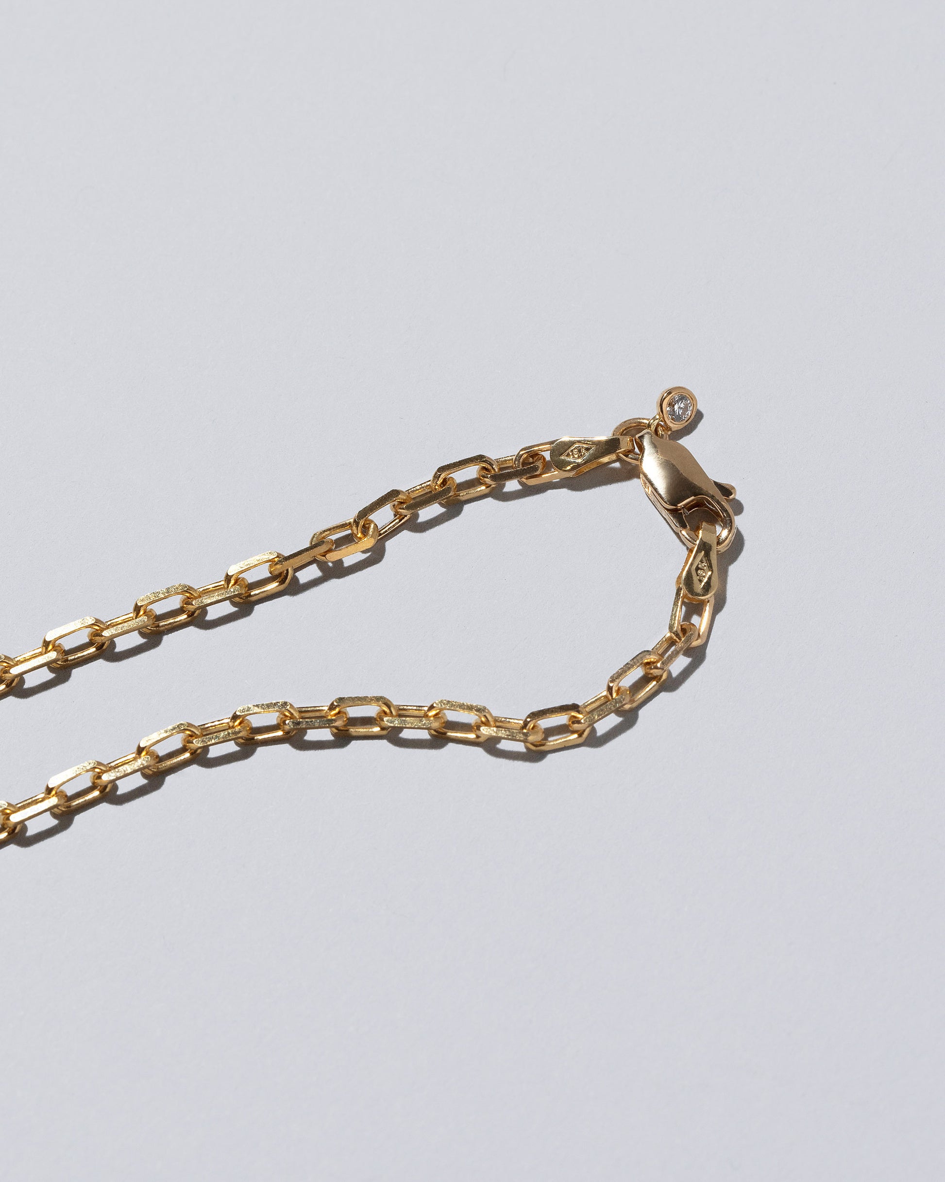 View from the back of the Reverence Necklace on light color background.