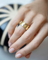 Gold 2.5mm Ripple Band and Gold Yogo Mine Blue Montana Sapphire 6mm Square Cut Piet Band on model.
