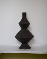 Giselle Hicks Soft Black Zig Zag Bottle on light color background.