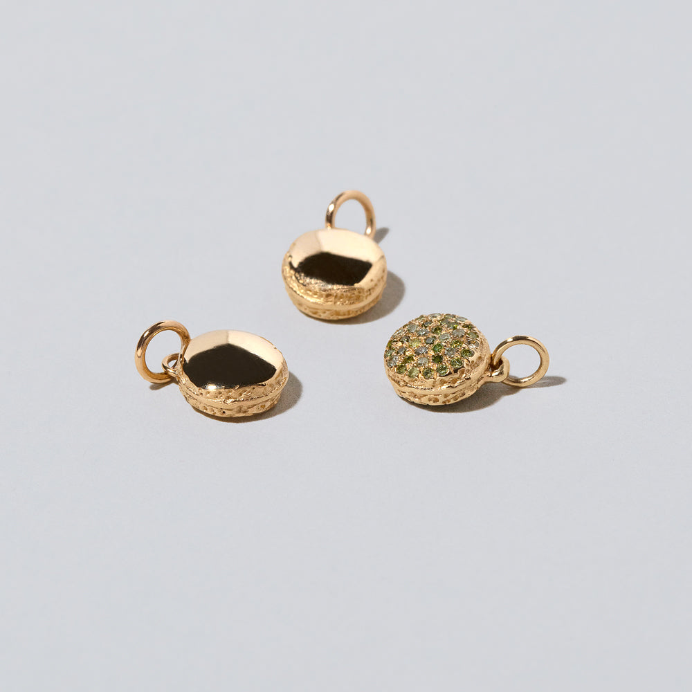 product_details::Mini Macaron Charm - 14k Gold on light color background.
