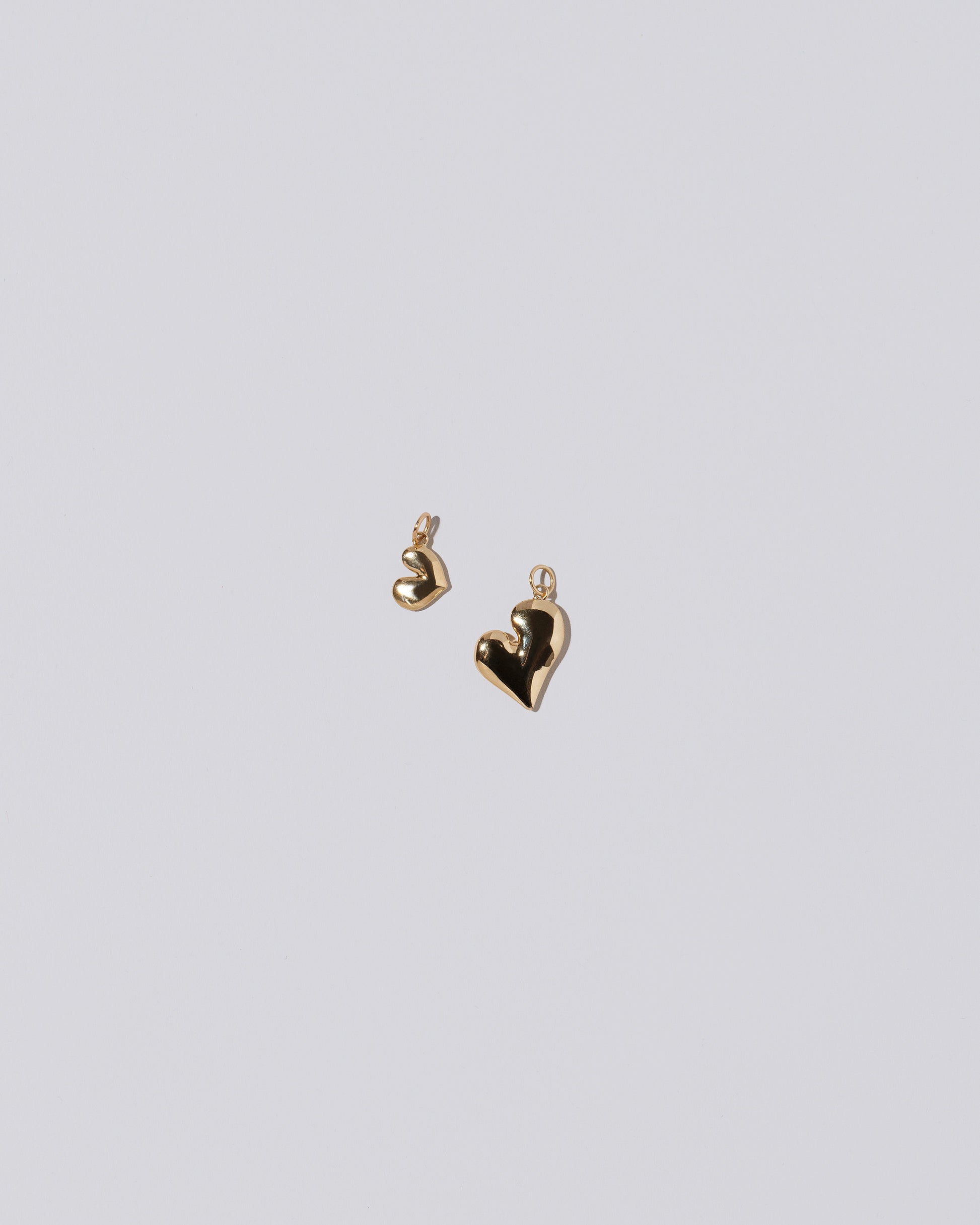 Thousand & One Night Heart Charms on light color background.
