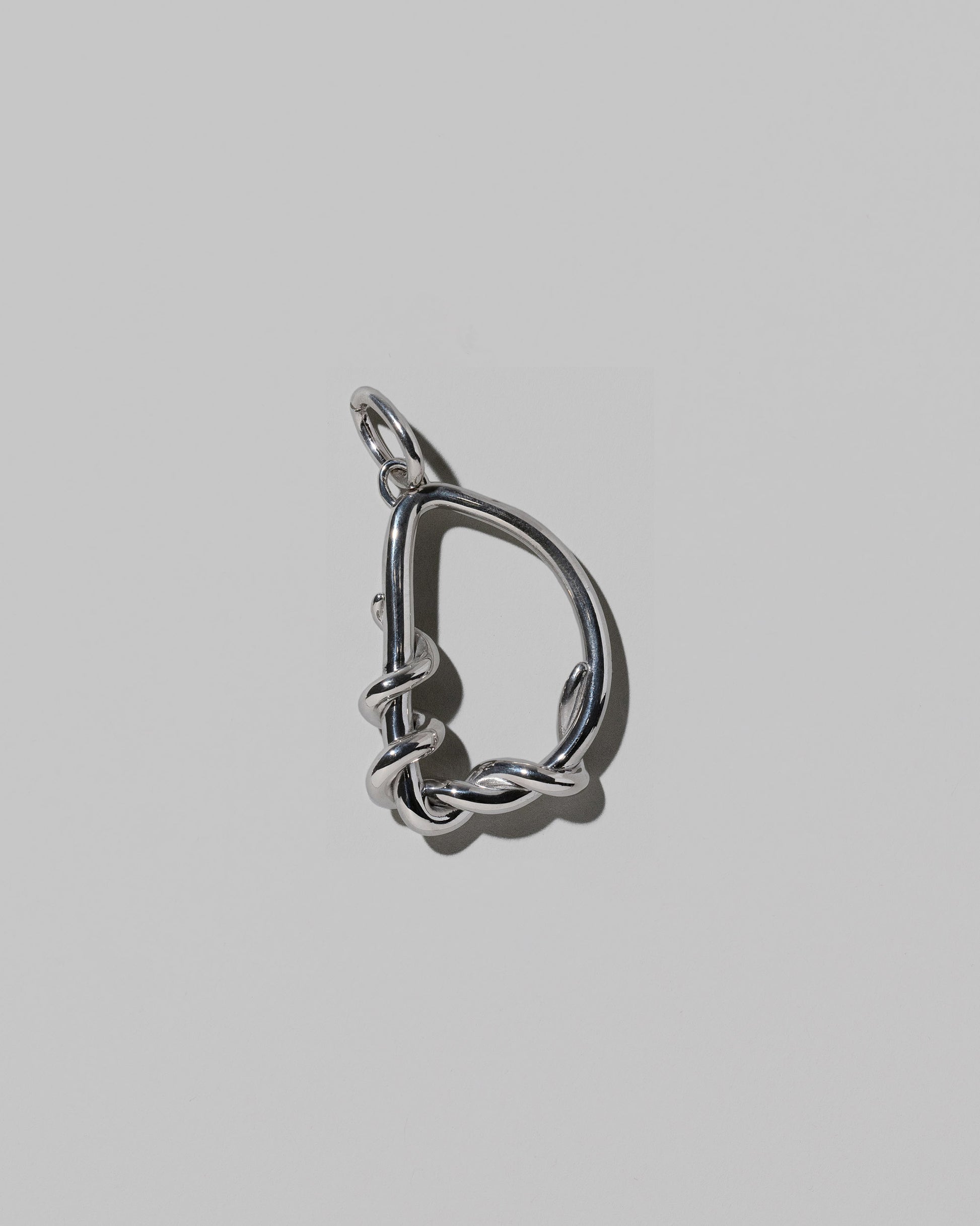 CRZM Large Letter D Charm set in sterling silver on light color background.