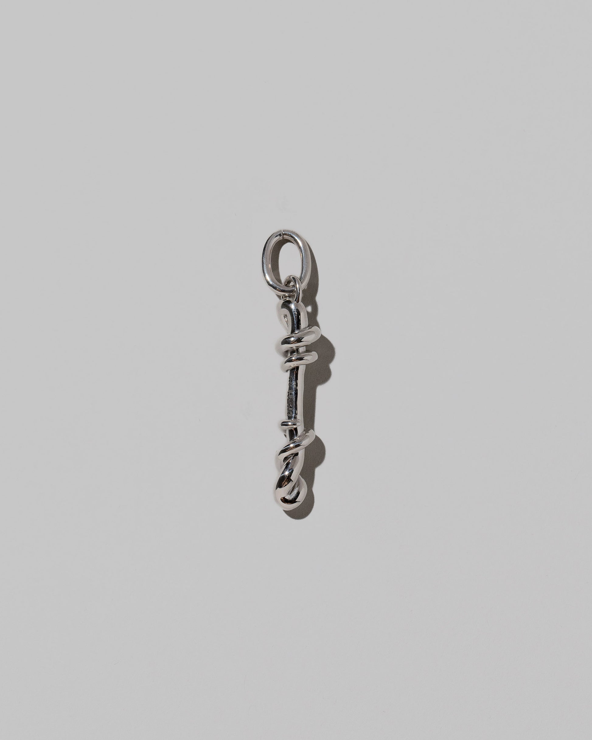 CRZM Large Letter I Charm set in sterling silver on light color background.
