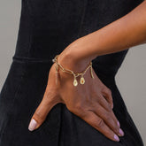 product_details::Avocado Charm, Asparagus Charm, Carrot Charm and Long Loop Chain Bracelet on model.