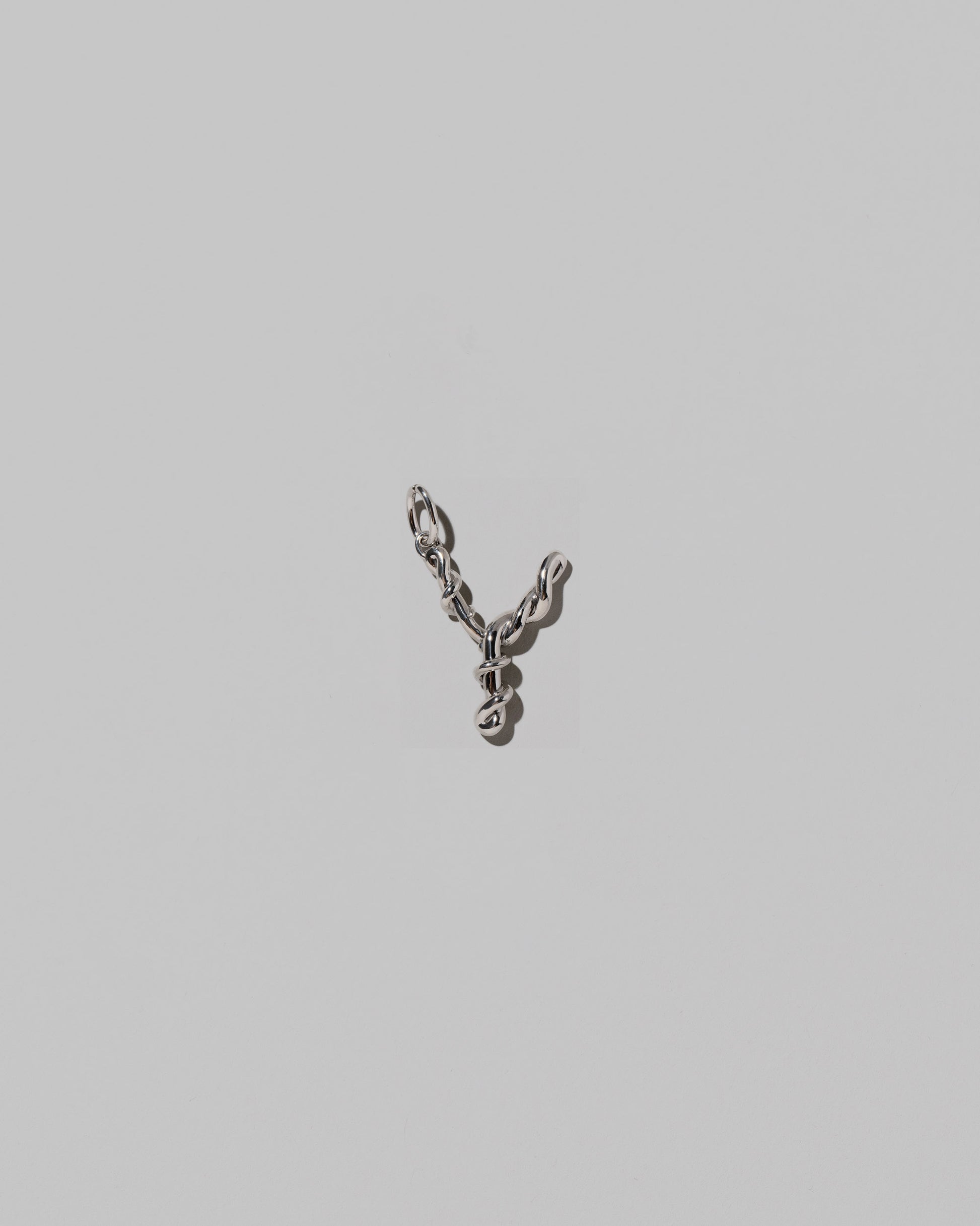 CRZM Medium Letter Y Charm set in sterling silver on light color background.