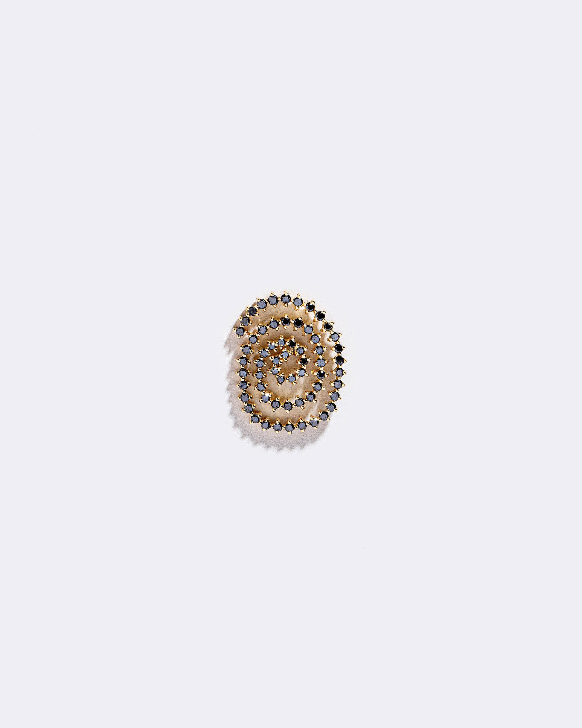 Left Black Diamond Cycle of Rebirth Earring Single on light color background.