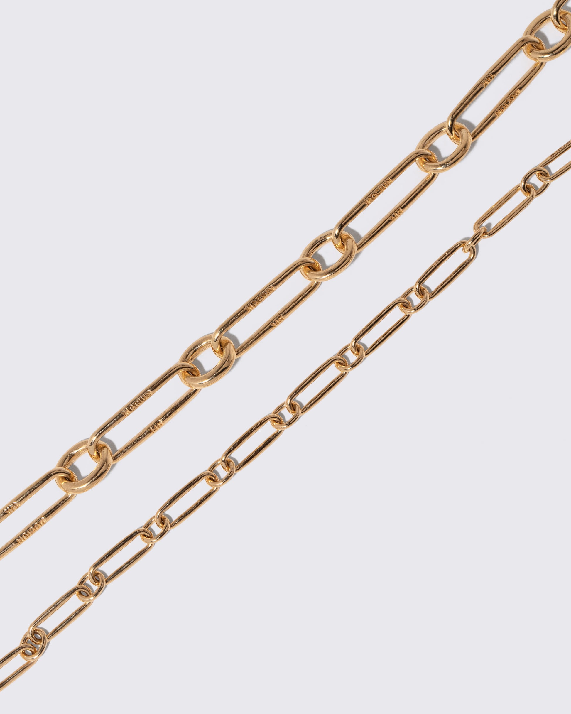 Closeup details of the Link Bracelet and Petite Link Bracelet on light color background.