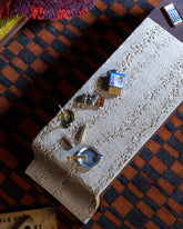 Styled image featuring the Chocolate Bar Charm, with the Joint Charm, Lit Joint Charm, Dirty Martini Charm and Instant Ramen Charm.
