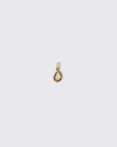 Green Sapphire Gusher Charm on light color background.