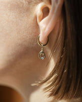 Styling Huggie Hoop Earring Single and Green Sapphire Gusher Charm on model.