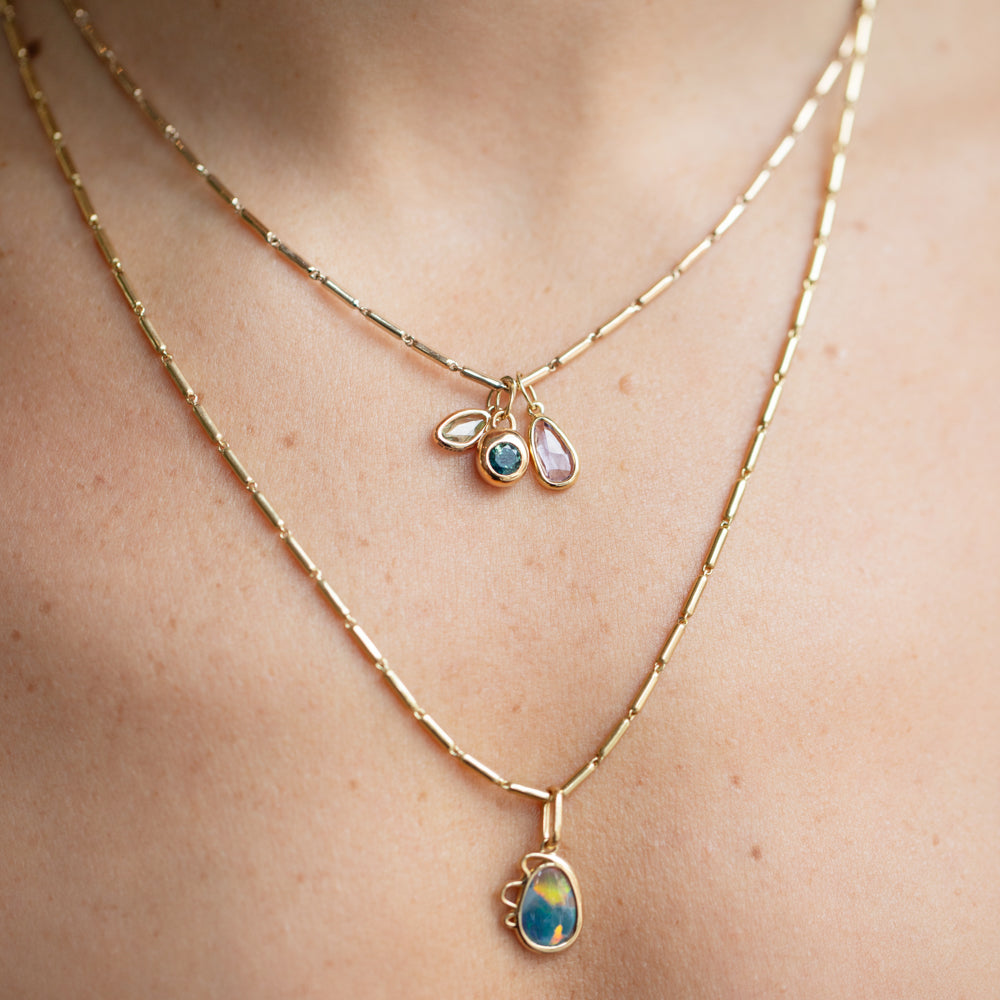 product_details::Harmony Pendant, Sapphire Birthstone Level Charm and Purple and Yellow Sapphire Gusher Charm with Gold Butter Chain Necklaces on model.