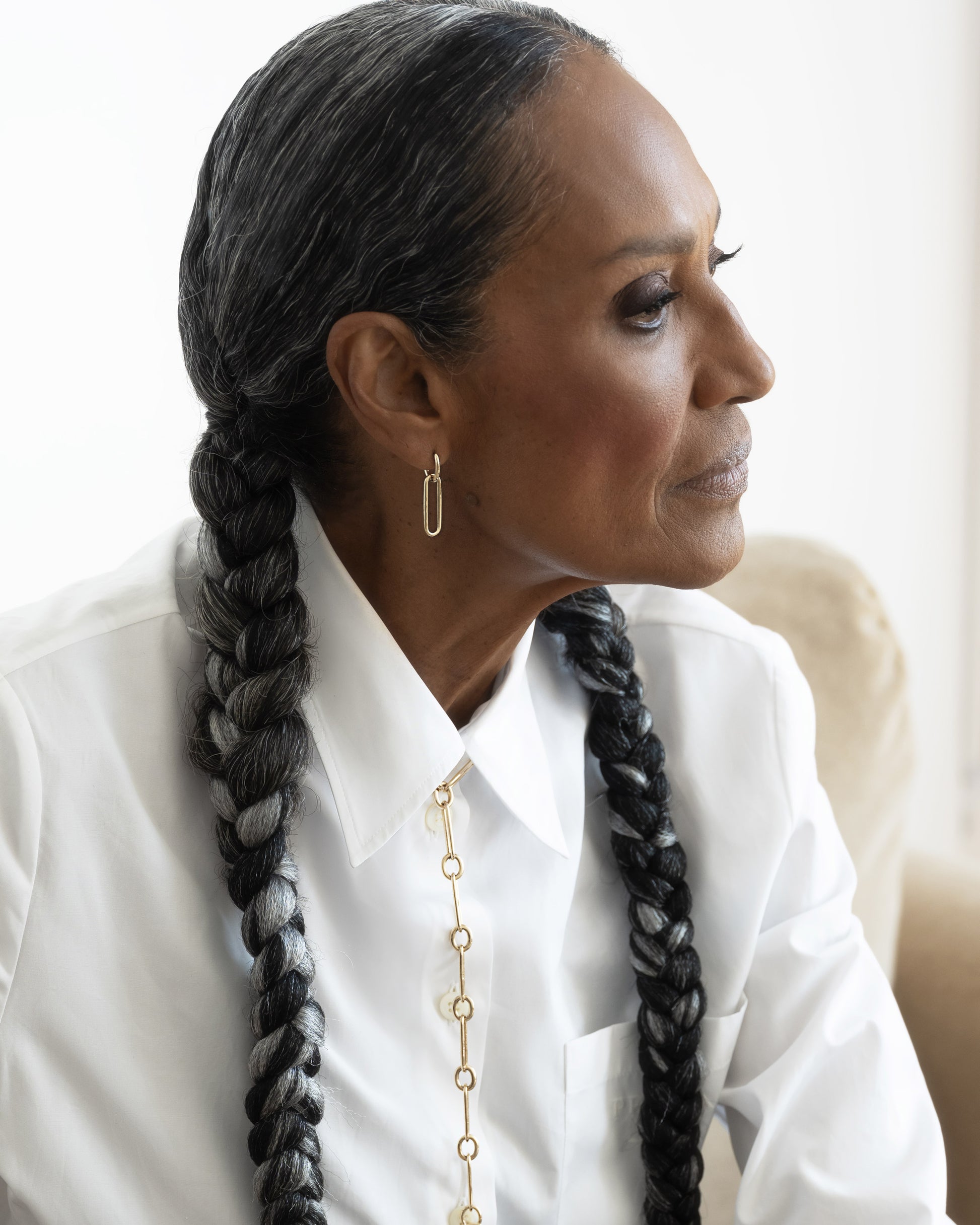 Styled image on model featuring Link Huggie Hoop Earrings and Link Necklace.