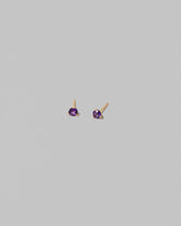 Petite Amethyst Martini Stud Earrings on light color background.