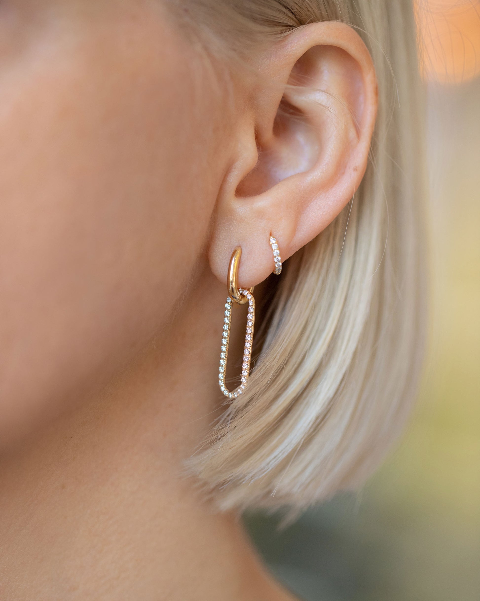 Huggie Gold Pavé Snack Hoop Earrings and Pavé Link Huggie Hoop Earrings on model.