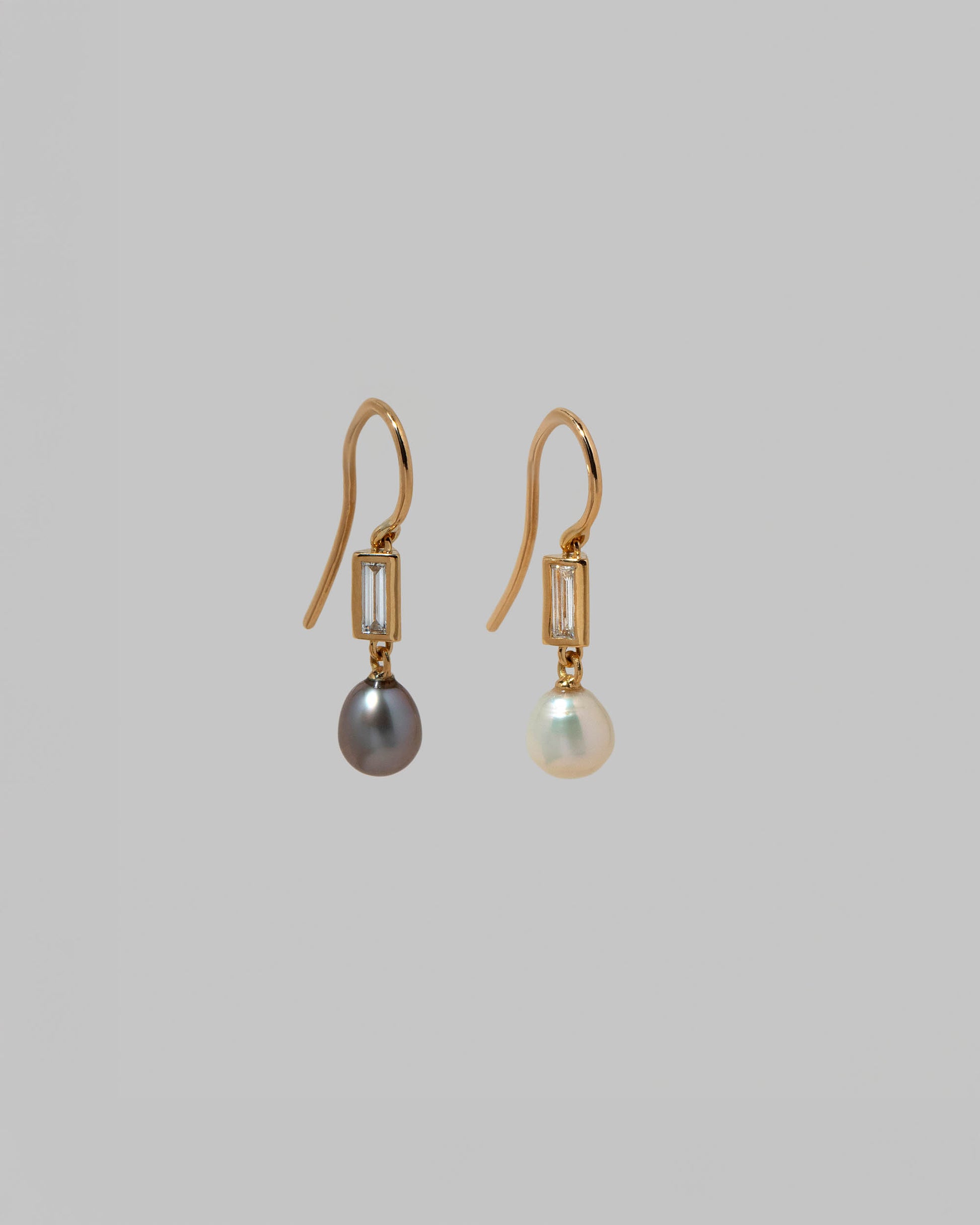 View from the side of the Poseidon Earrings on light color background.