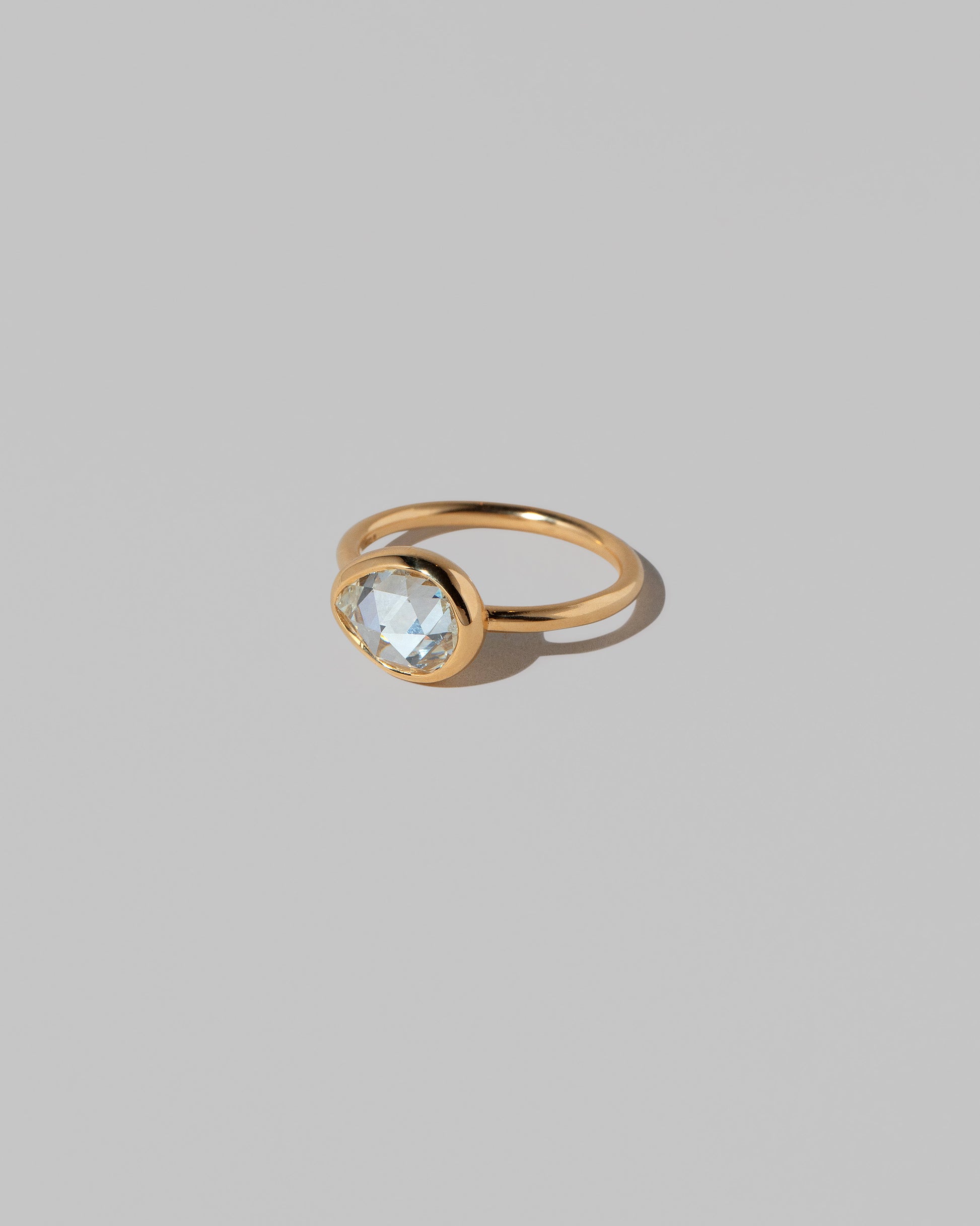 View from the side of the Gusher Diamond Ring 027 on light color background.