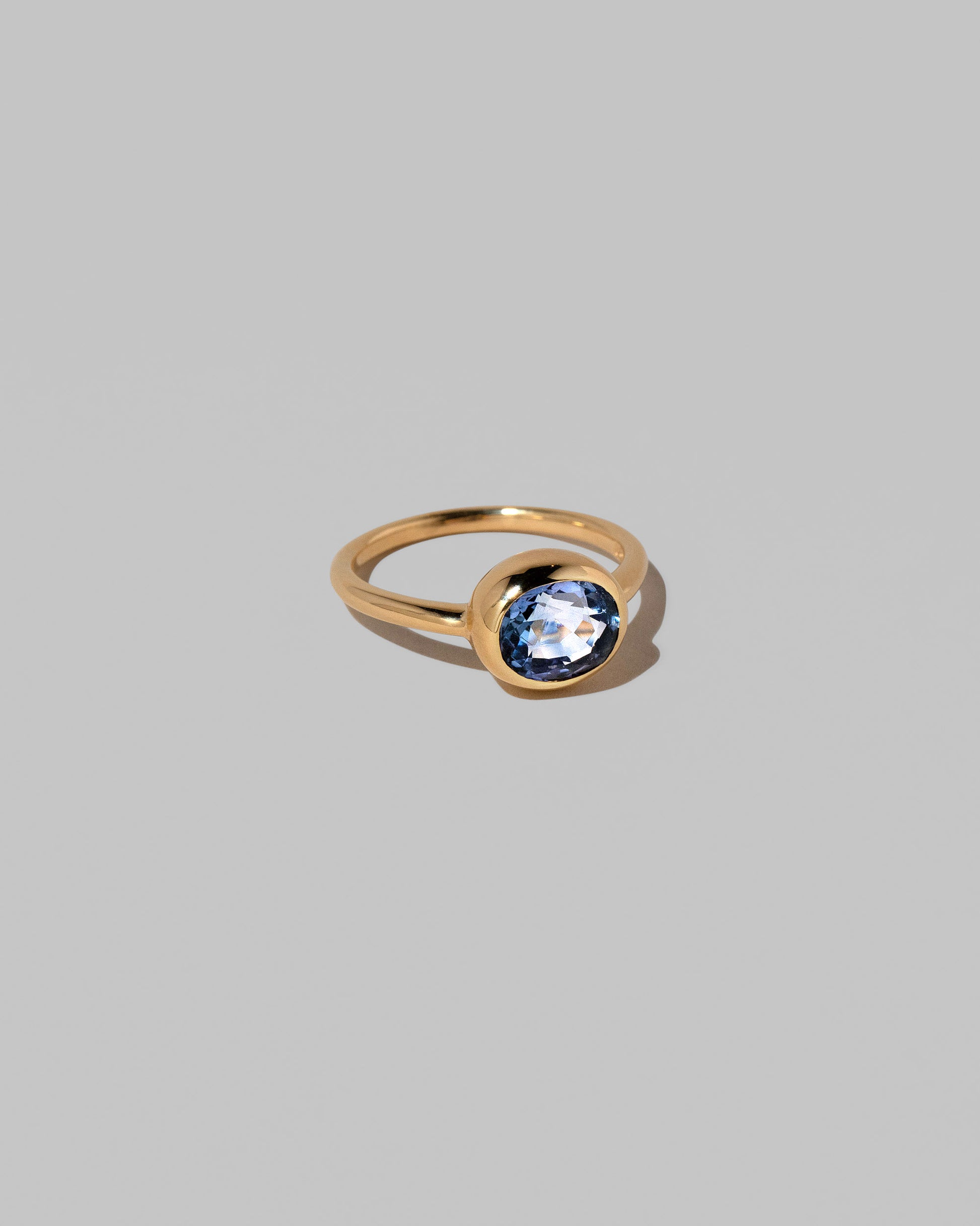 View from the side of the Geyser Blue Sapphire Ring 002 on light color background.