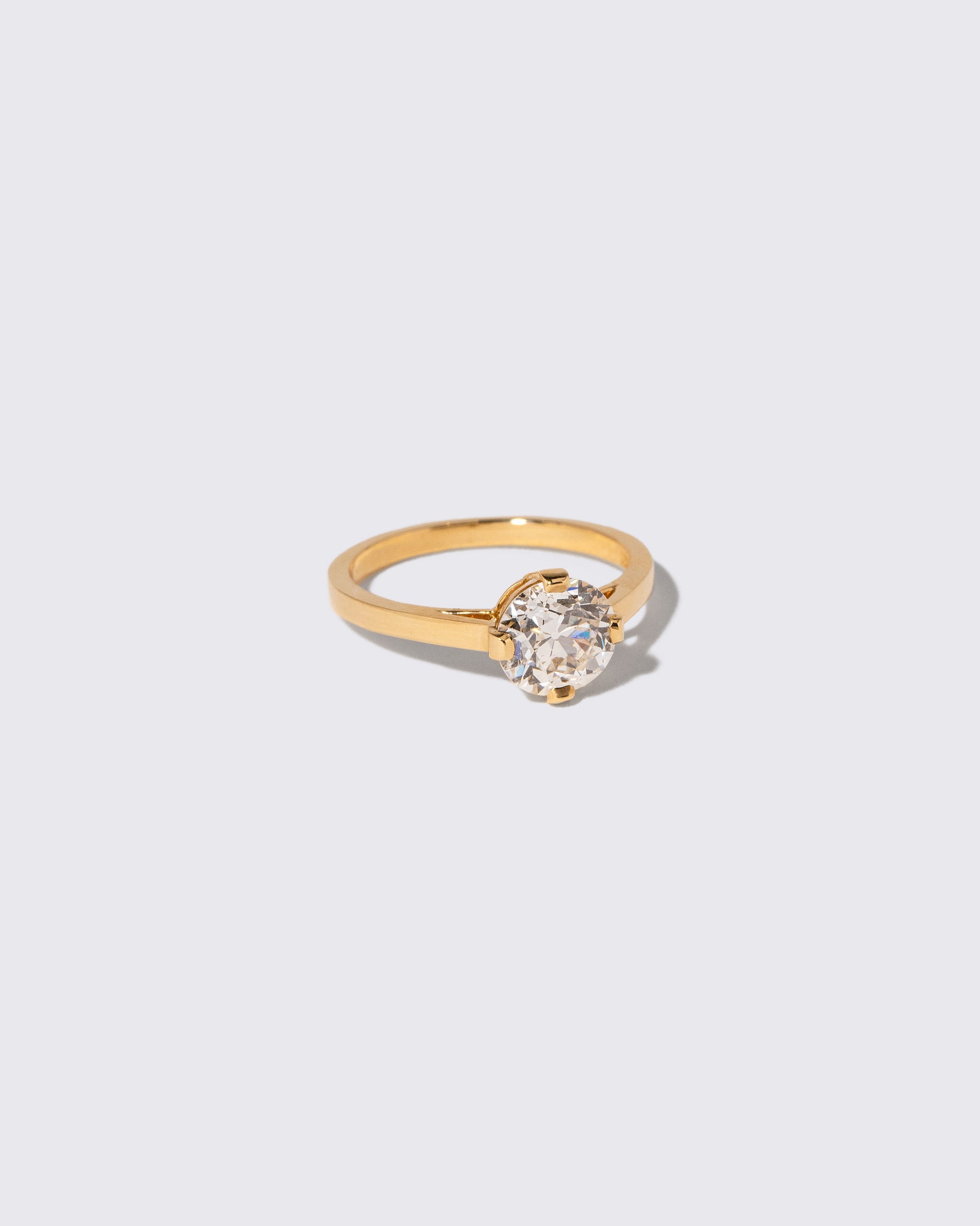 View from the side of the Super White Diamond Barragán Ring on light color background.