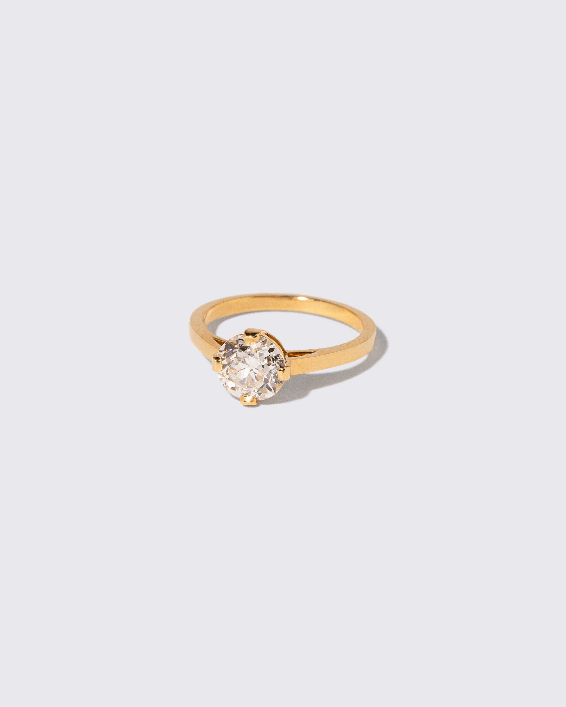 View from the side of the Super White Diamond Barragán Ring on light color background.