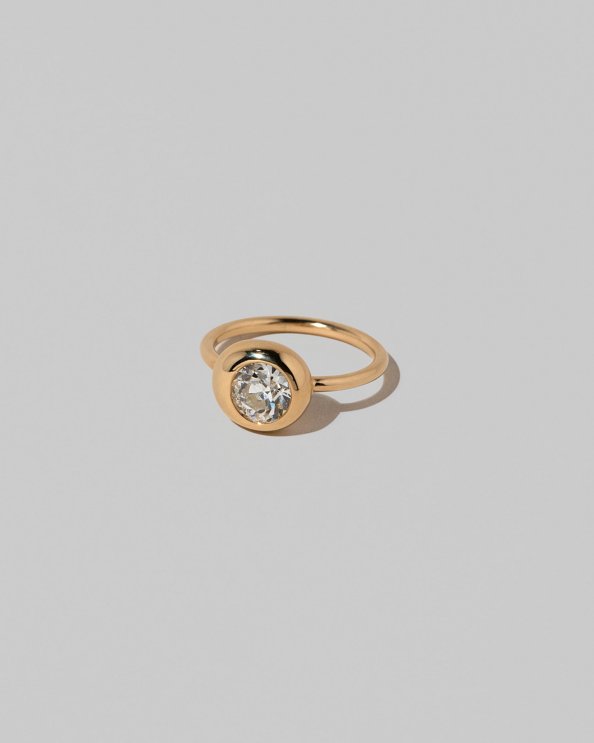 View from the side of the Diamond Grand Level Ring on light color background.