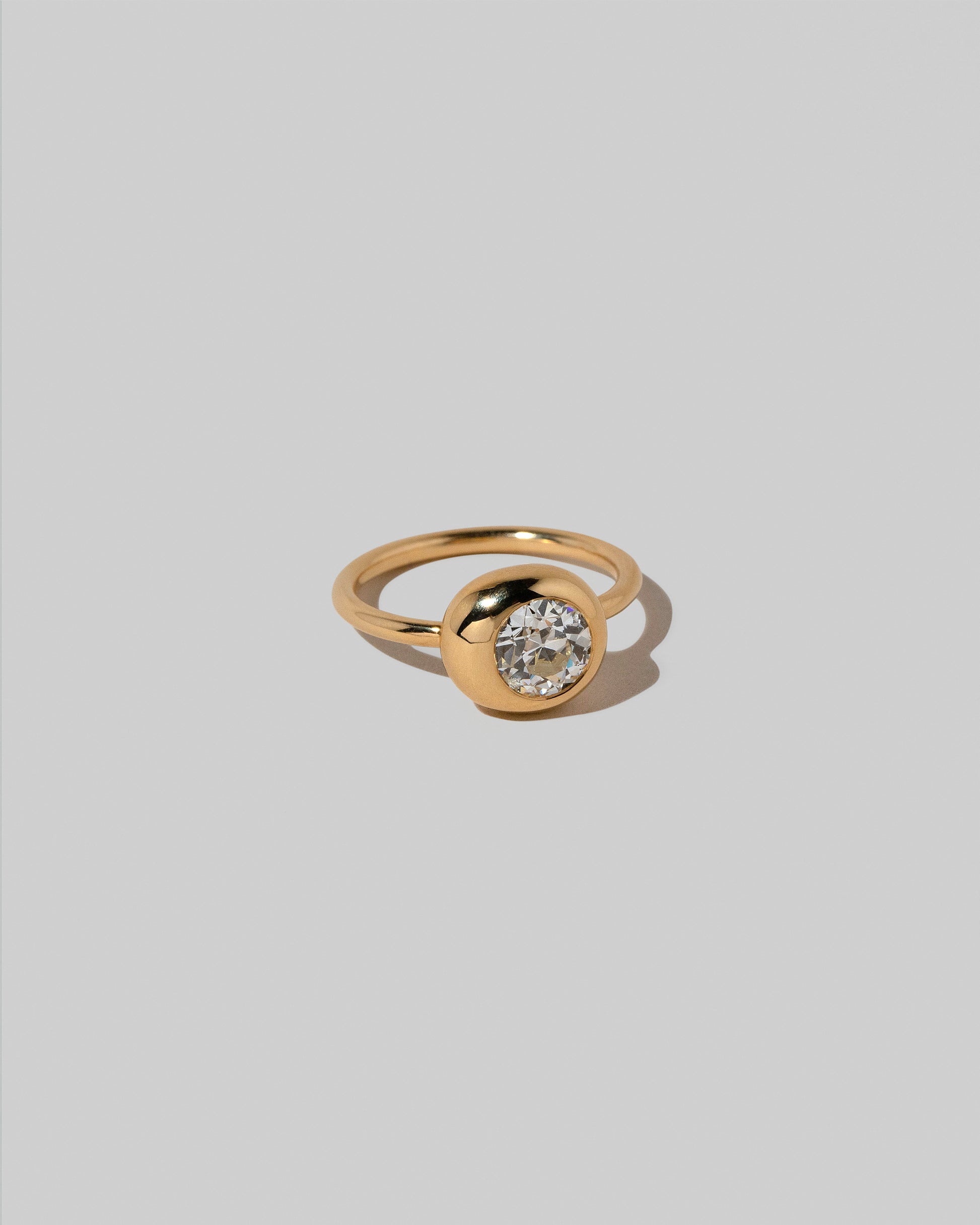 View from the side of the Diamond Grand Level Ring on light color background.