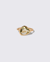 Green Sapphire Gusher Ring on light color background.