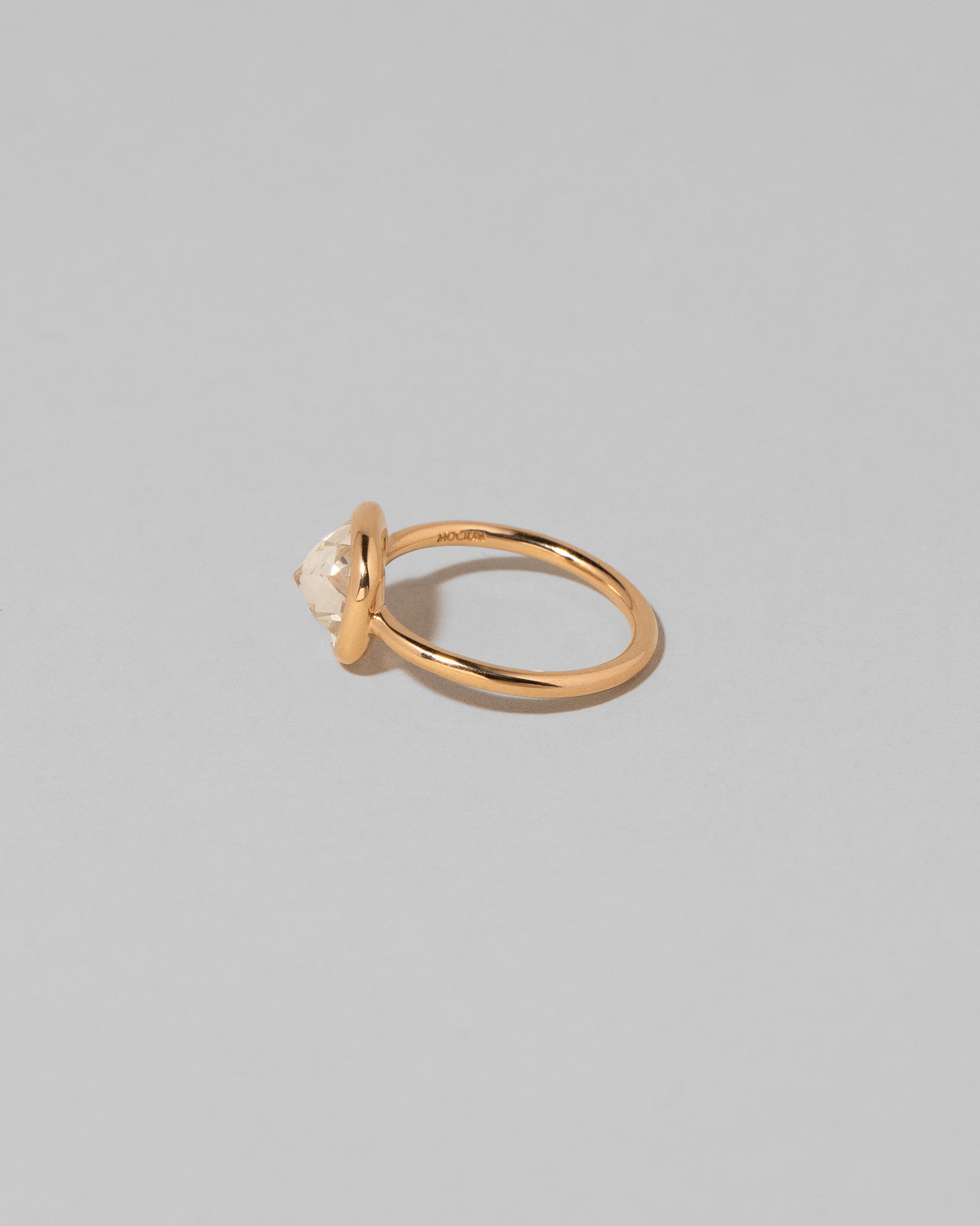 View from the back of the Gusher Chartreuse Sapphire Ring 003 on light color background.