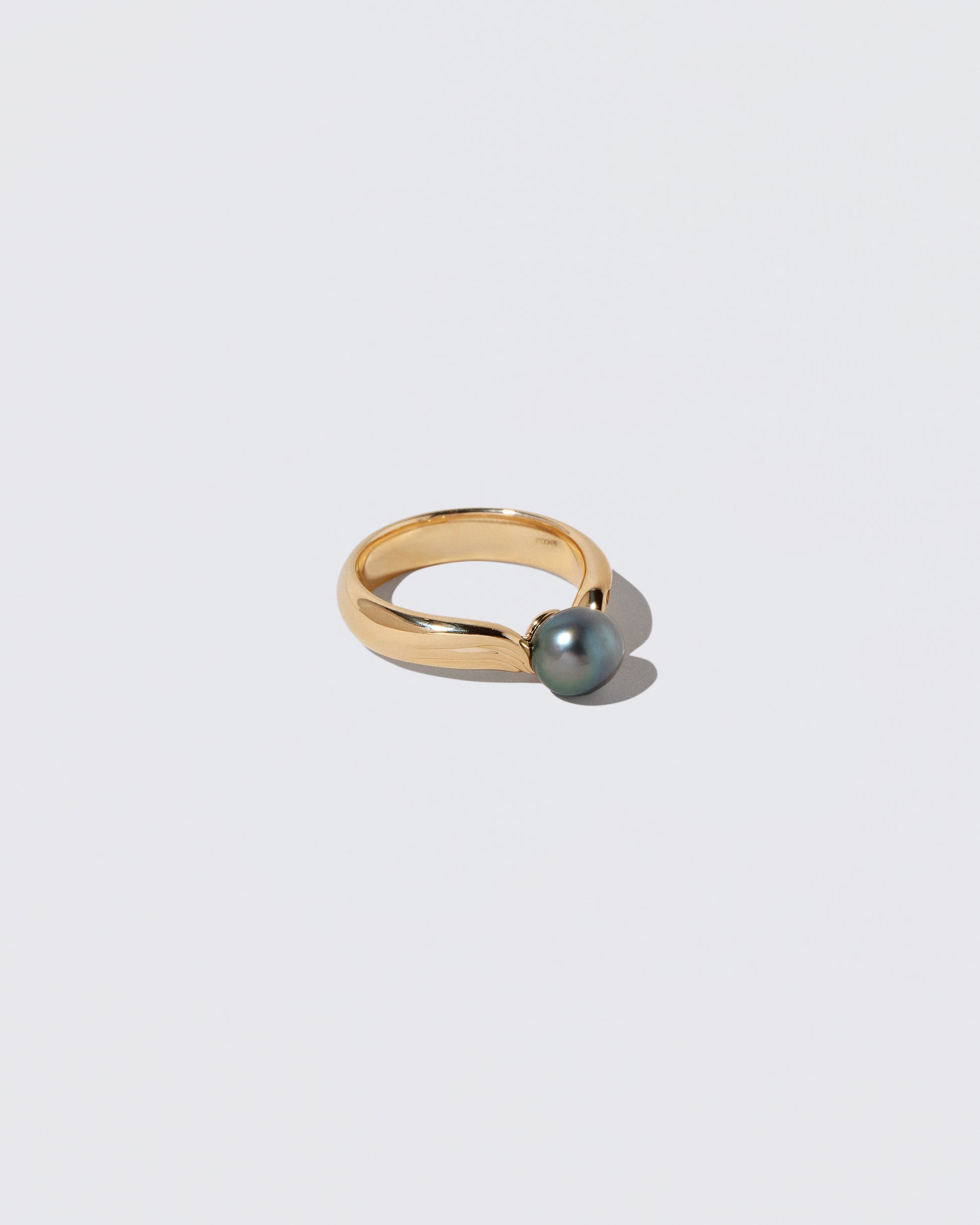View from the side of the Scylla Ring on light color background.