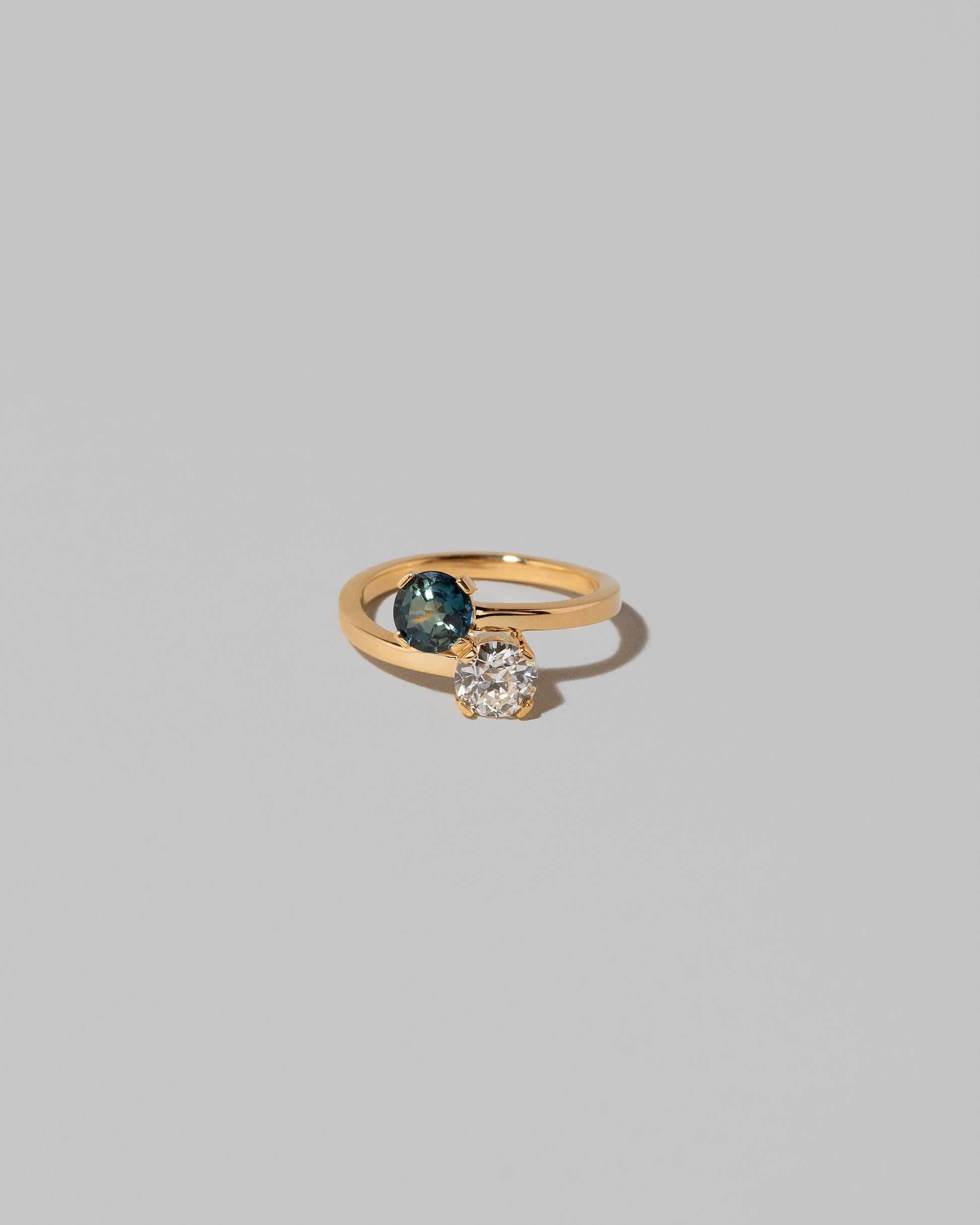 Sapphire & Diamond Union Ring on light color background.