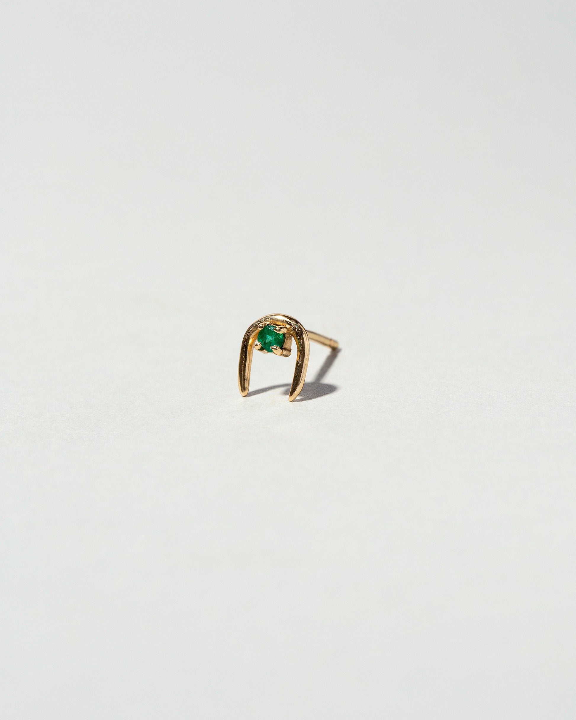 Emerald Moon Catcher Stud Earring Single on light color background.