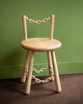 Pat Kim Chain Chair One on green color background.