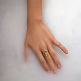product_details::Blue Sapphire Level Ring, Green Sapphire Level Ring, and Champagne Diamond Grand Level Ring on model.