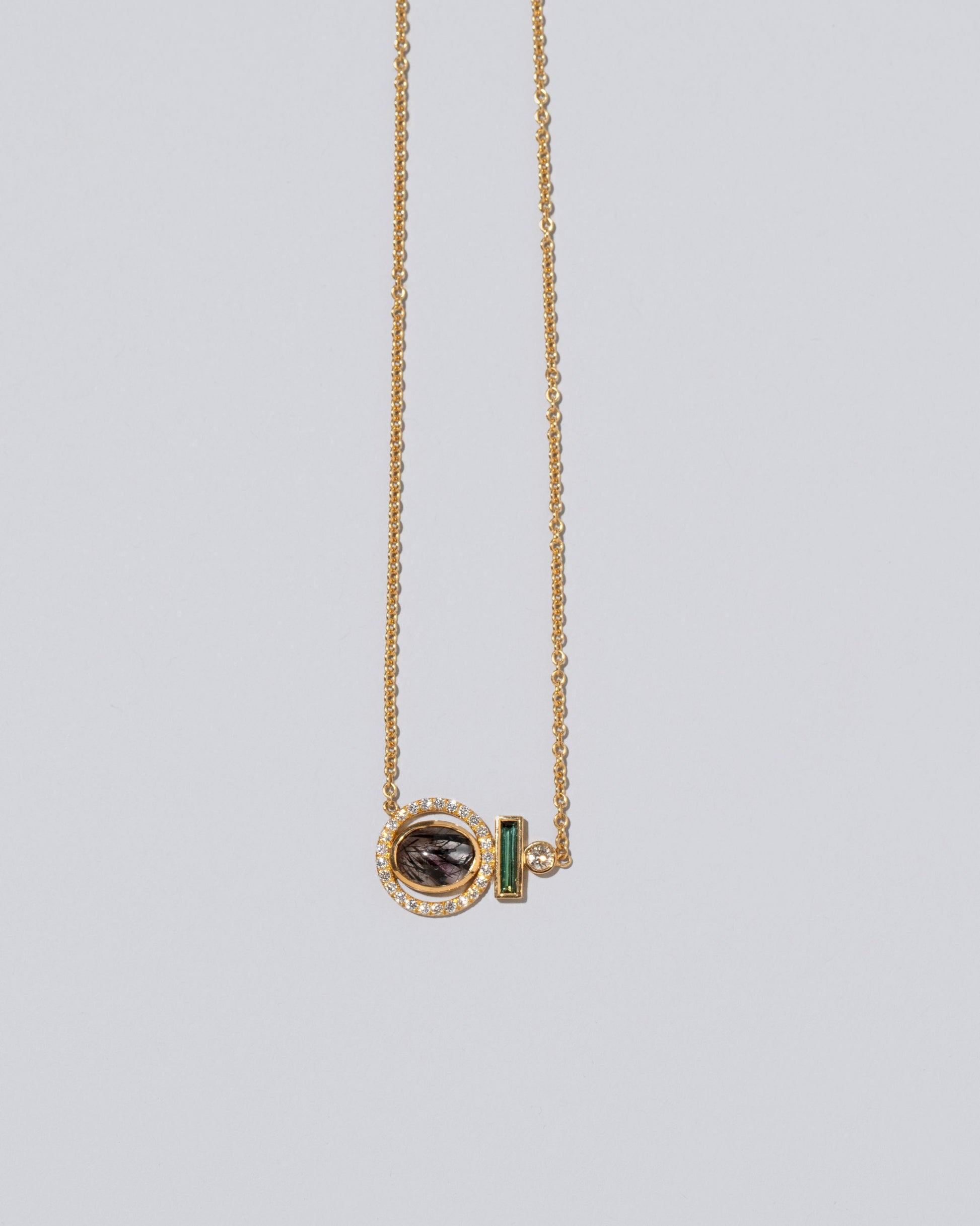 Closeup detail of the Mystical Change Necklace on light color background.