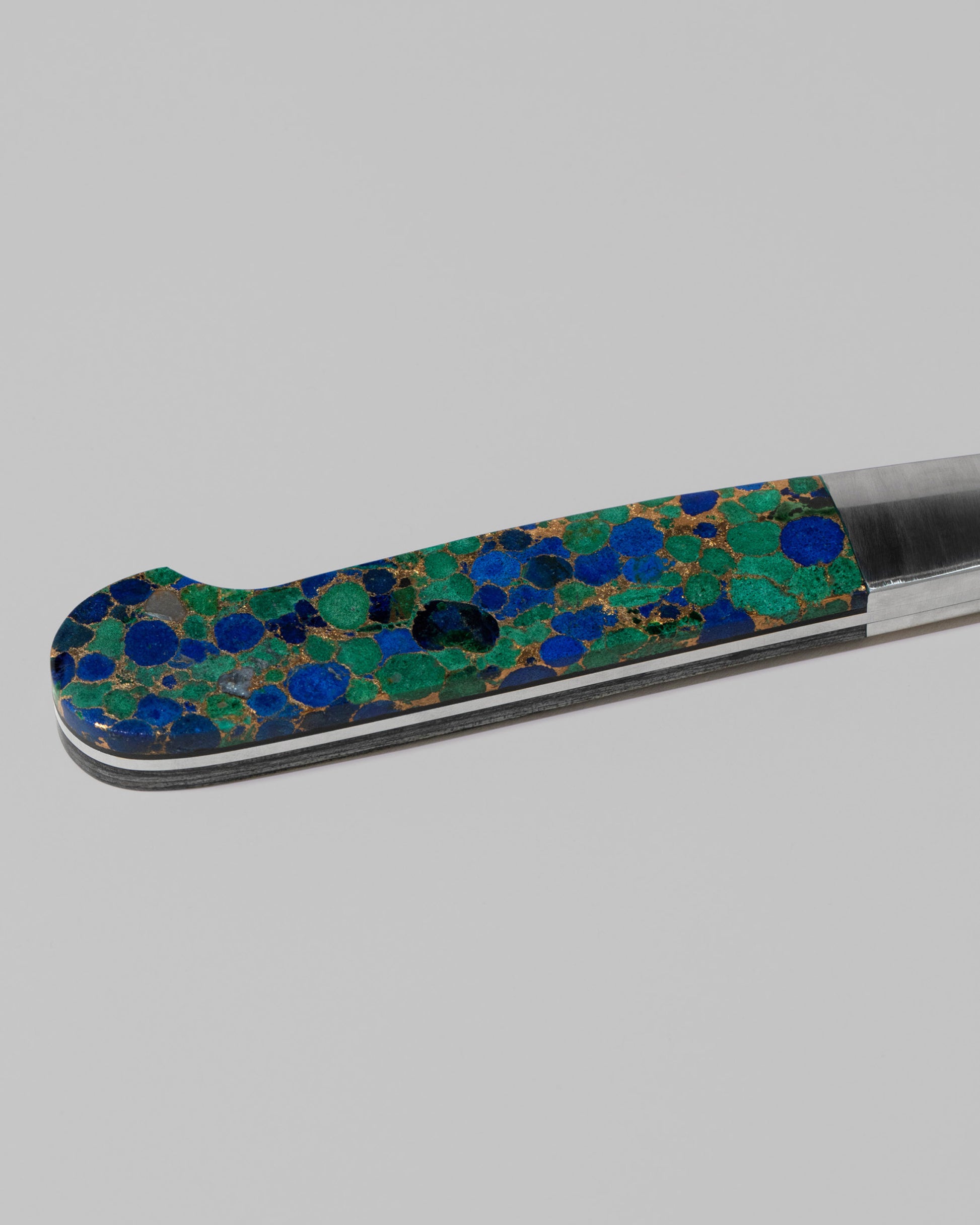Closeup details of the Closeup details of the Santa Fe Stoneworks Azurite and Lapis Bread Knifes on light color background.