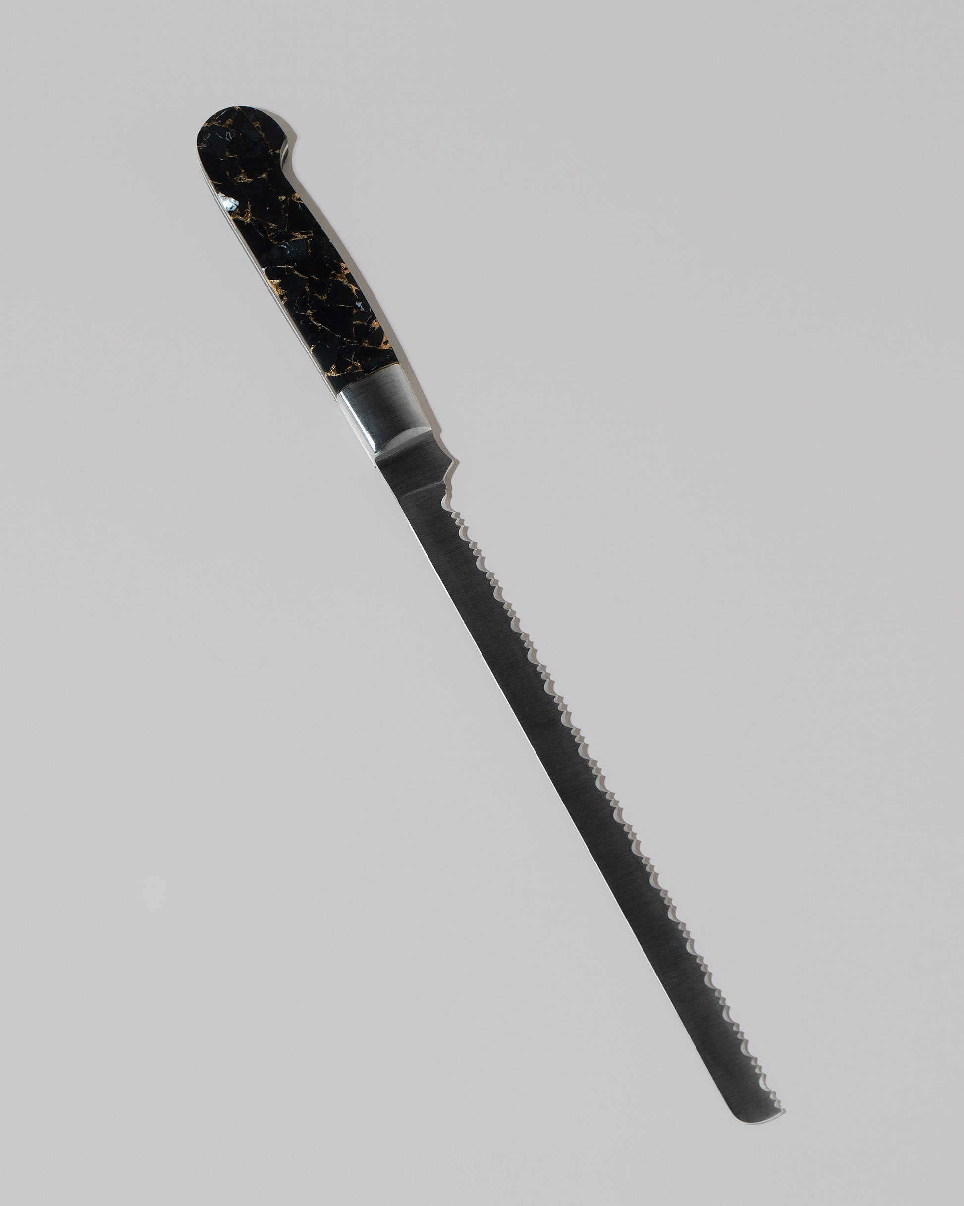 Santa Fe Stoneworks Black Buffalo Turquoise Bread Knife on light color background.