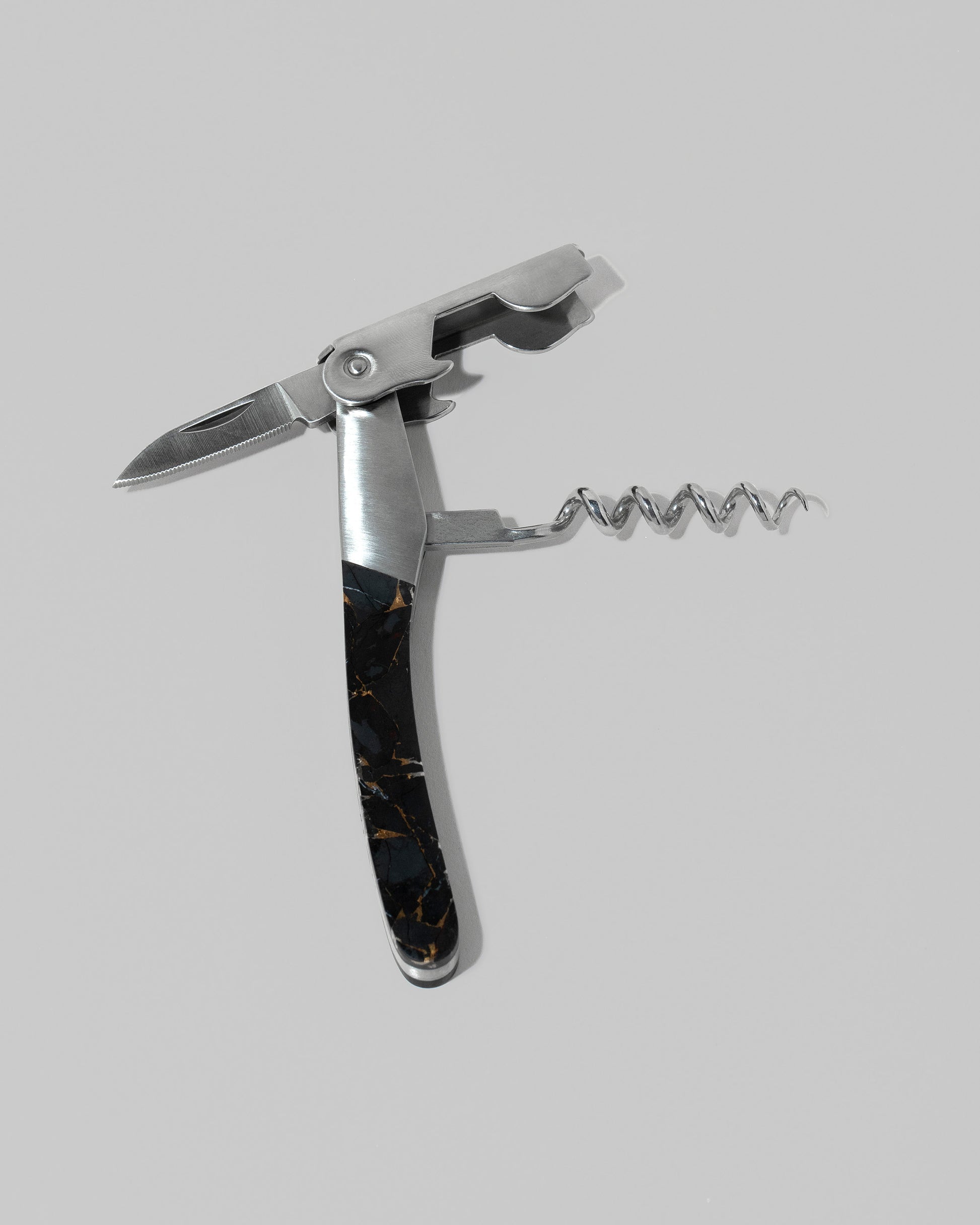 Detail view of the Santa Fe Stoneworks Black Buffalo Turquoise Waiter's Knife on light color background.