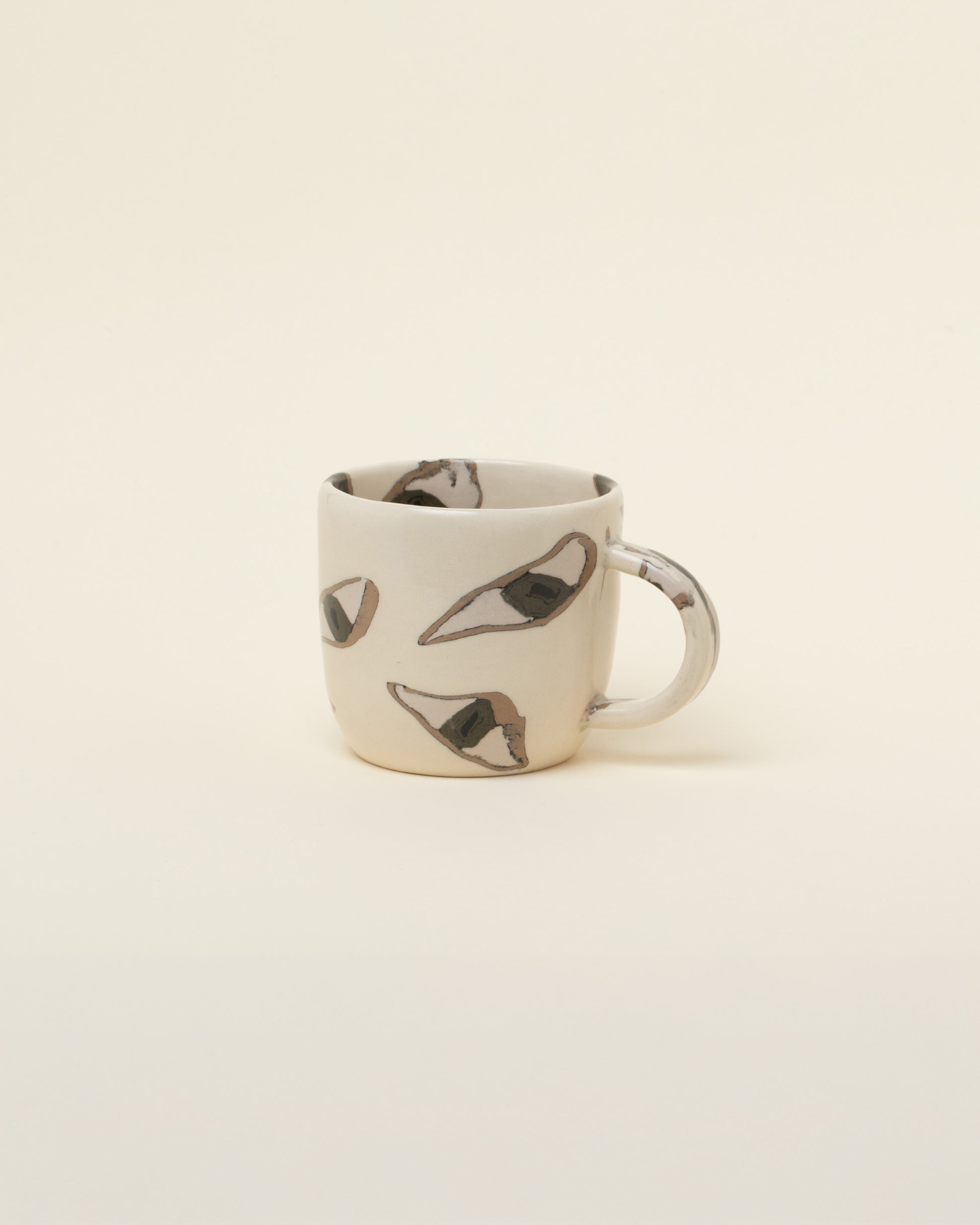 Slush Club Nerikomi Eye Mug on light color background.