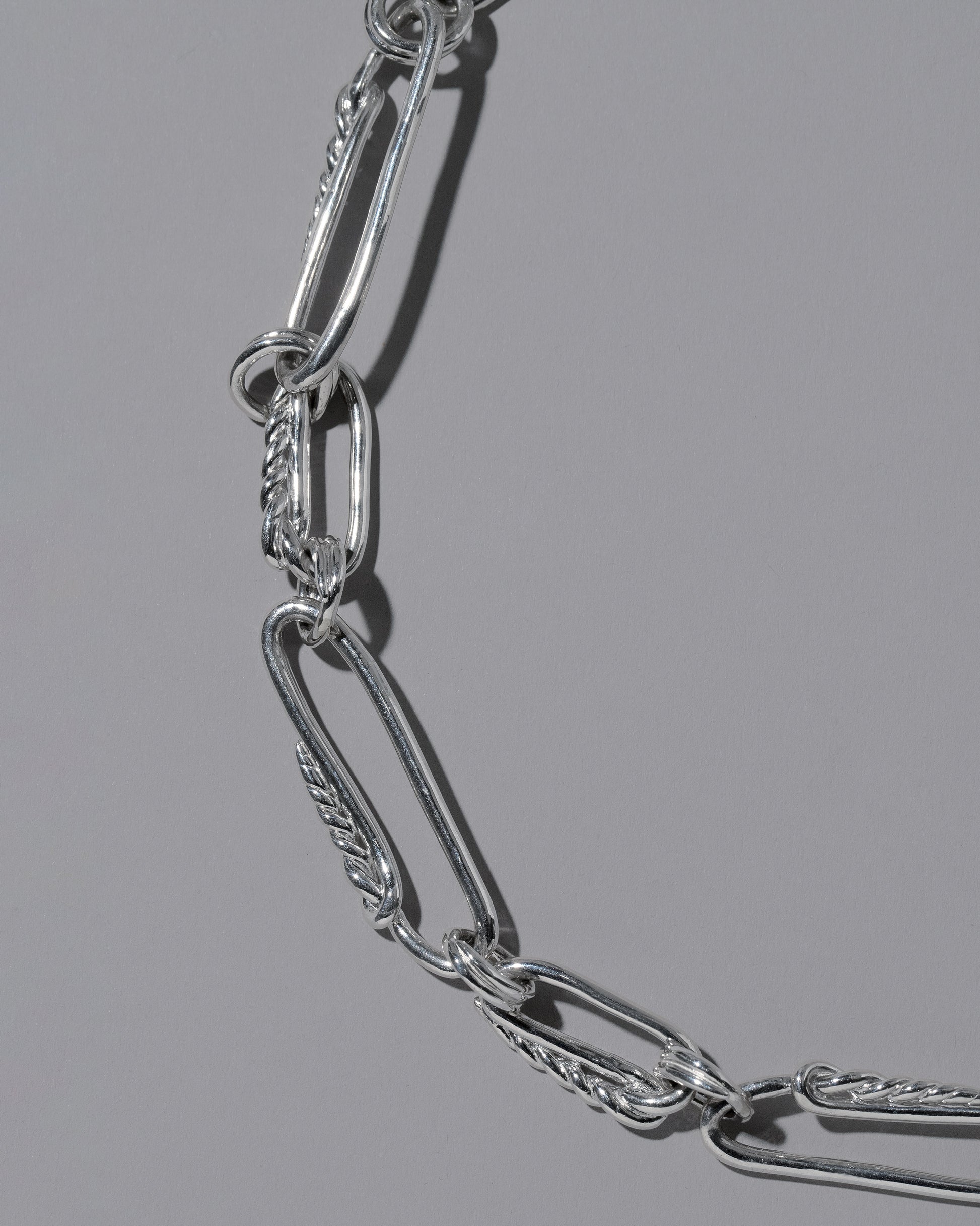 Closeup details of the CRZM Sterling Silver Ophiolite Bracelet on light color background.