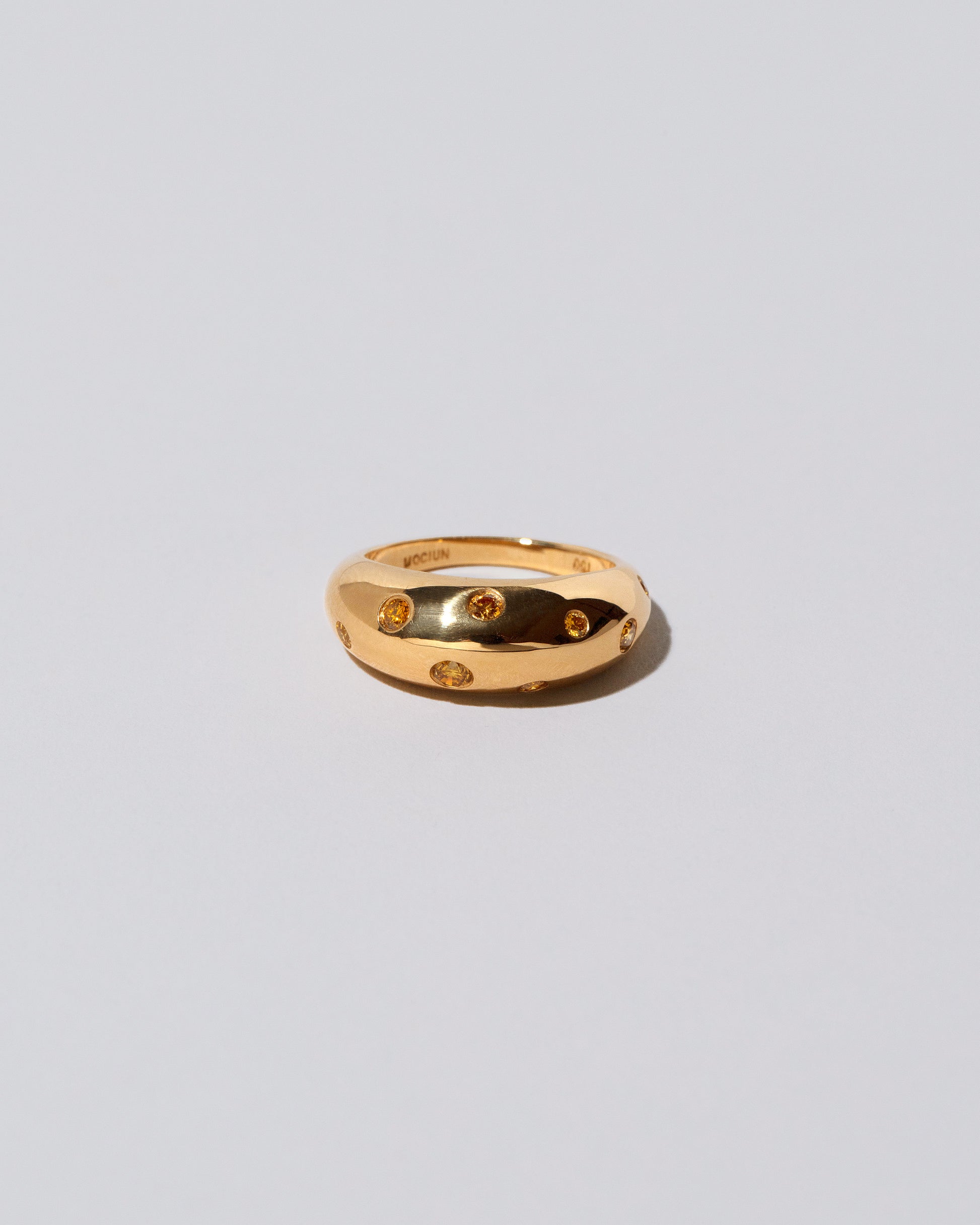 Gold Yellow Diamond Brilliant Cuts Light Cutter Band on light color background.