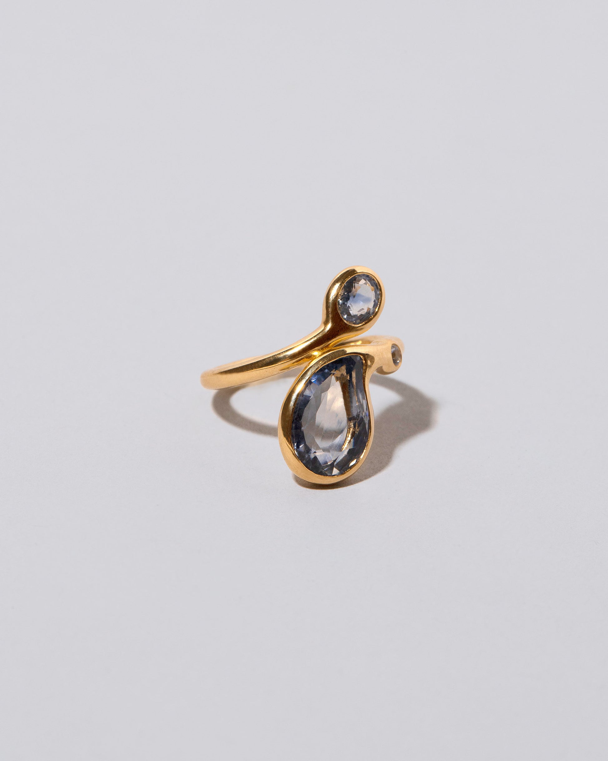 View from the side of the Three Tears Ring on light color background.